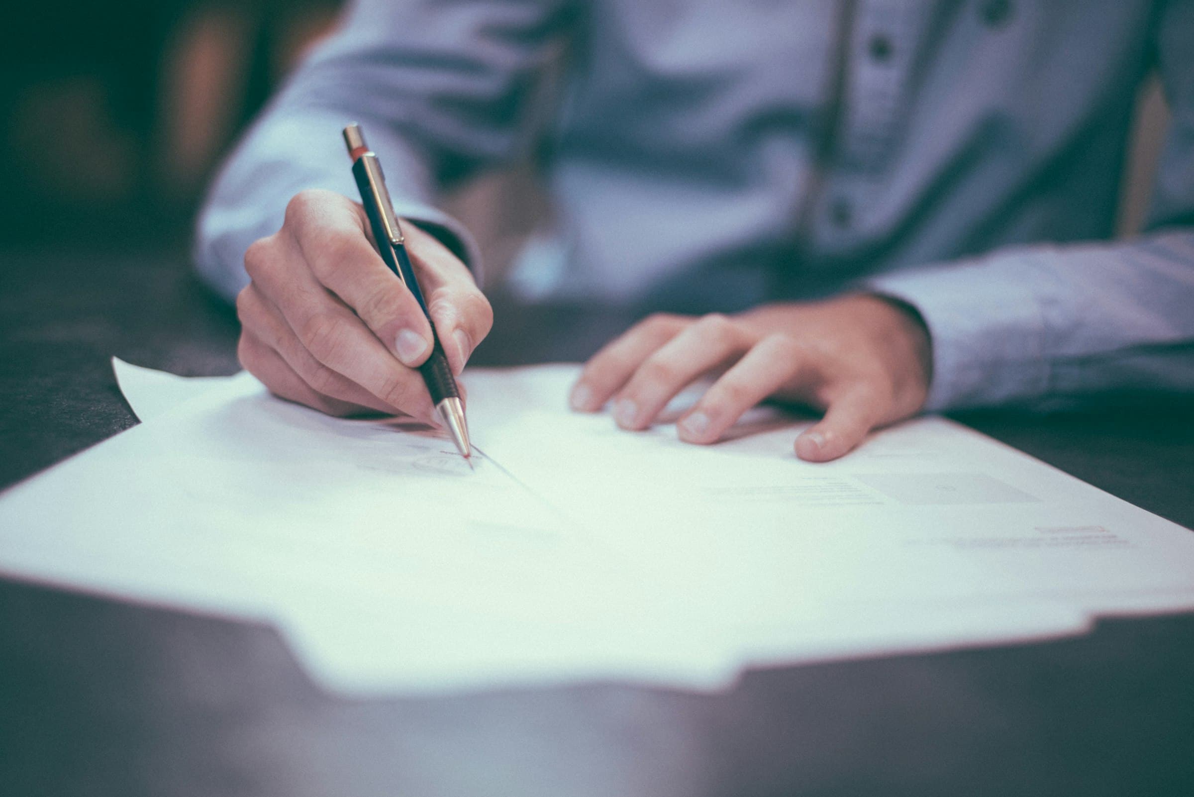 Legal documents and pen on a desk, representing the conveyancing process