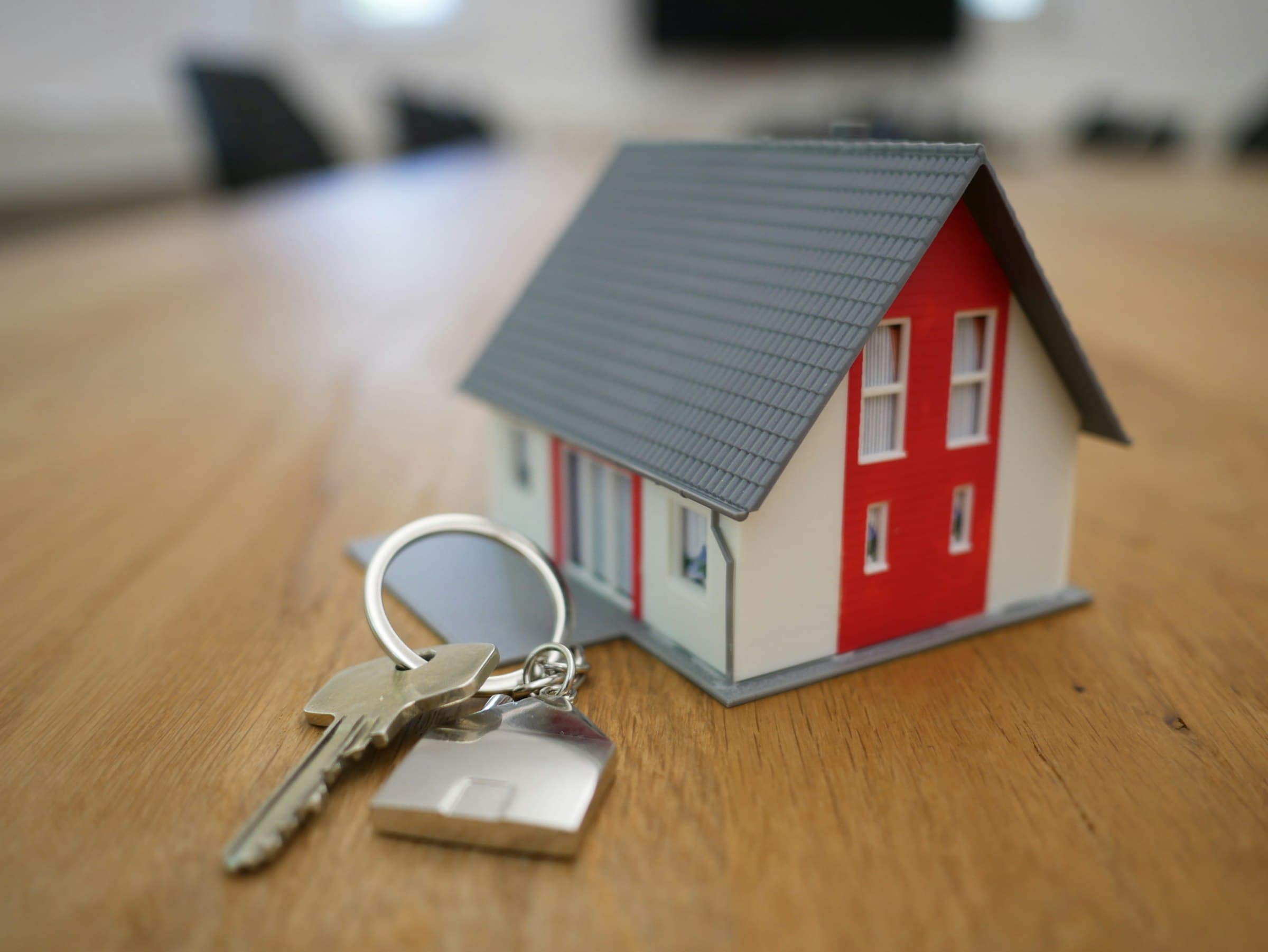 Hands exchanging house keys, representing completion of a property purchase